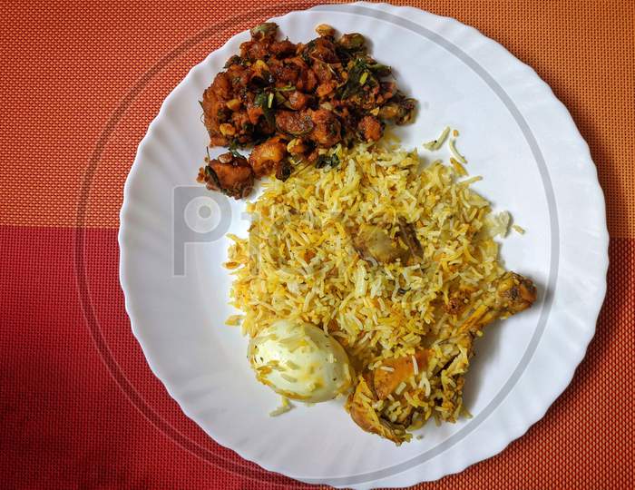 Chiken Biryani With Egg Traditional Vegetables Sauce Rice Cafe Indian Cuisine Restaurant Top View In White Plate On Colorful Background