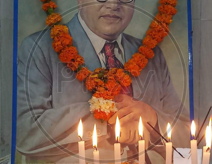 Dr.B.R Ambedkar photo frame with candles and garland on Ambedkar Jayanti Celebrations