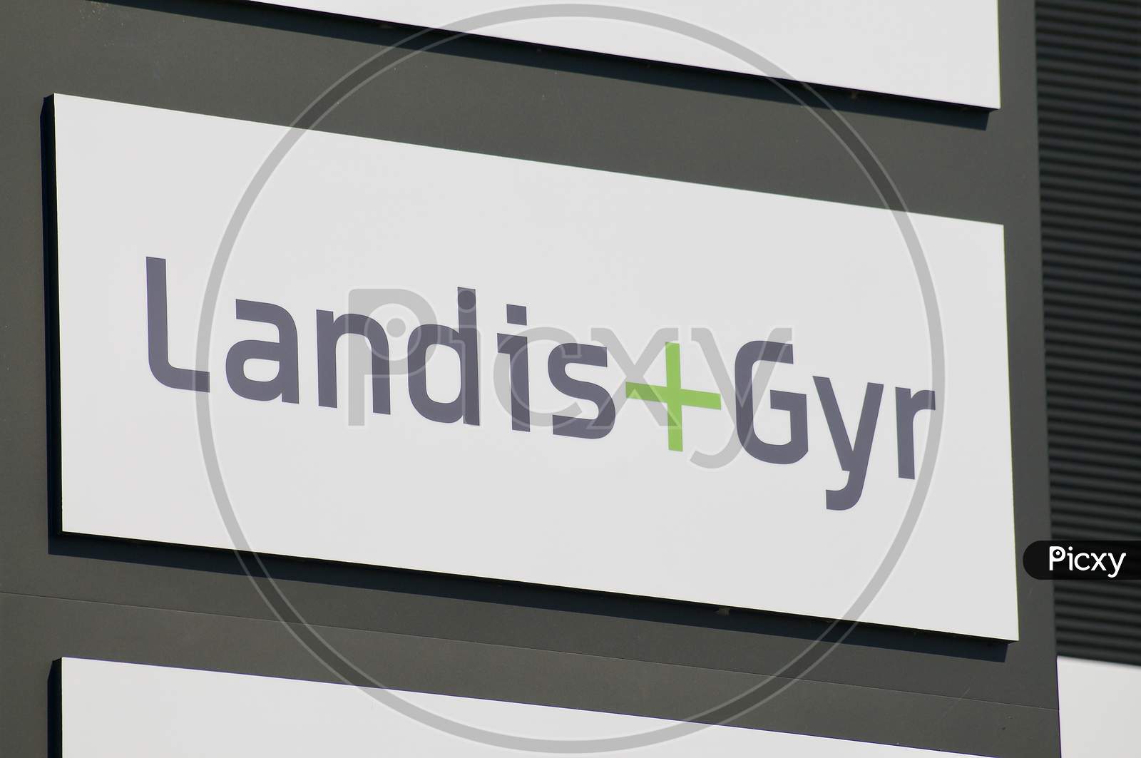 Landis + Gyr Sign Hanging In Front Of The Headquarters Building In Zug
