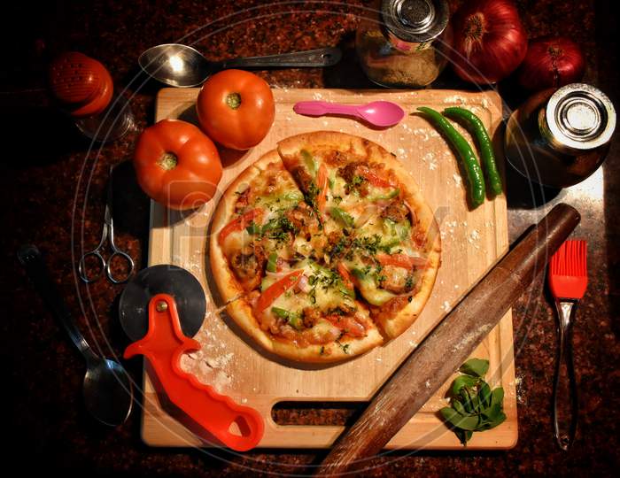 Traditional Italian Pizza, Vegetables, Ingredients On A Dark Metallic Background. Pizza Is Cooking In The Oven. Pizza Menu. View From Above. Space For Text.