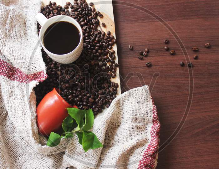 Coffee And Coffee Beans Fallen On A Table