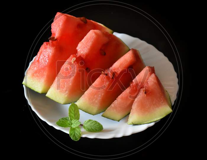 Red Watermelon Whole And Slice On Plate With Mint Leaf