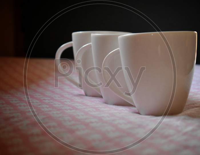 Three Coffee Cups On Old Pink Color Kitchen Table. Top View With Copy Space For Your Text, India