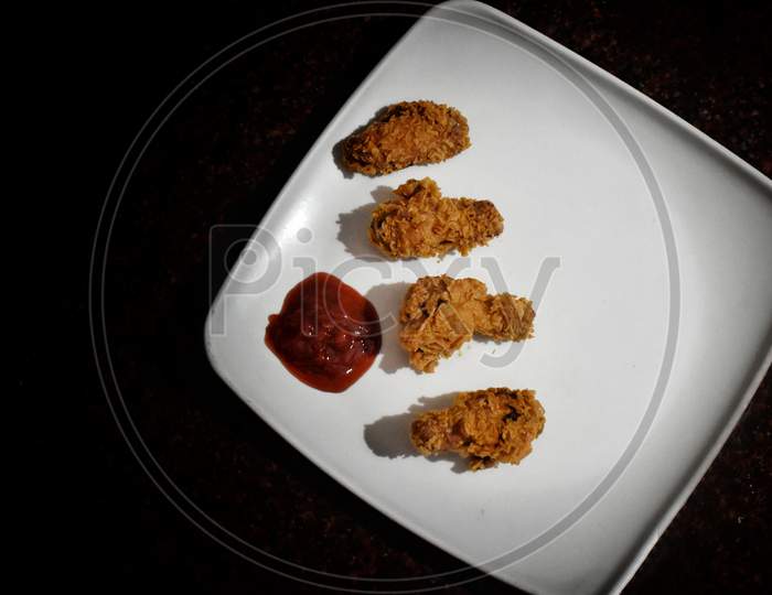 Barbecue Chicken Wings Close Up On White Plate With Ketchup And Sauce Shot With Selective Focus, India