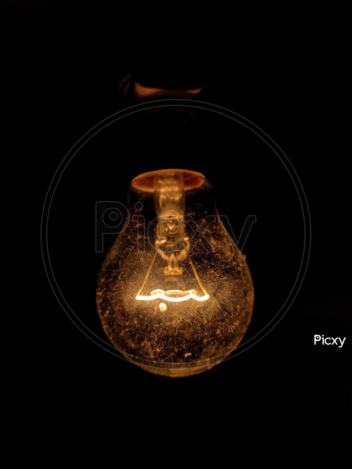 Old vintage light bulb glowing dim