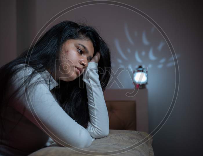 Worried Young Girl Woke Up During Night On Bed Due To Sleeplessness - Concept Of Insomnia,Sleeping Disorder, Depression Or Ptsd Or Post-Traumatic Stress.