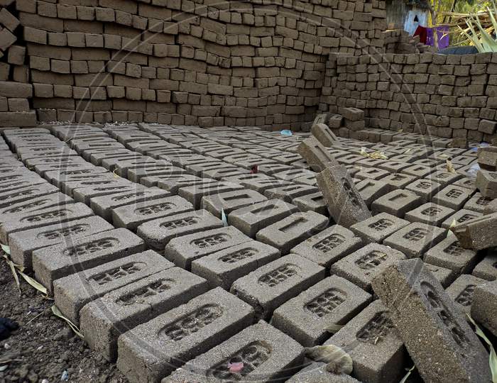 Raw brick laid out in stacks for drying