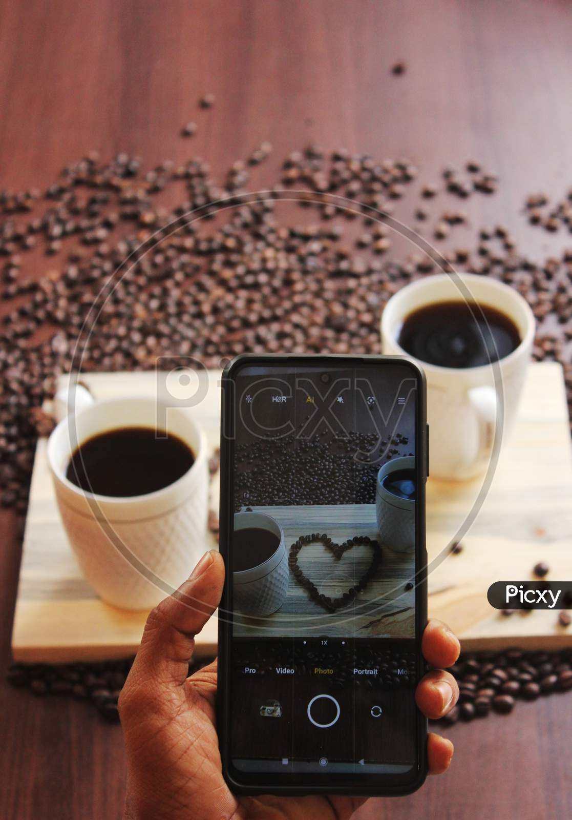 Coffee Beans In A Heart Shape Shot Through Mobile Phone