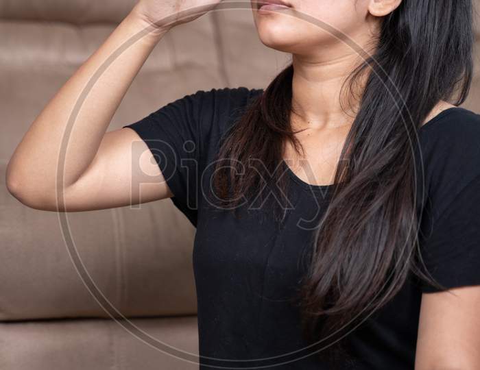 Portrait Of Young Girl In Sportswear Doing Nasal Or Nostril Breathing Exercise At Home - Concept Of Self-Care, Wellbeing And Healthy Lifestyle Or Millennials.