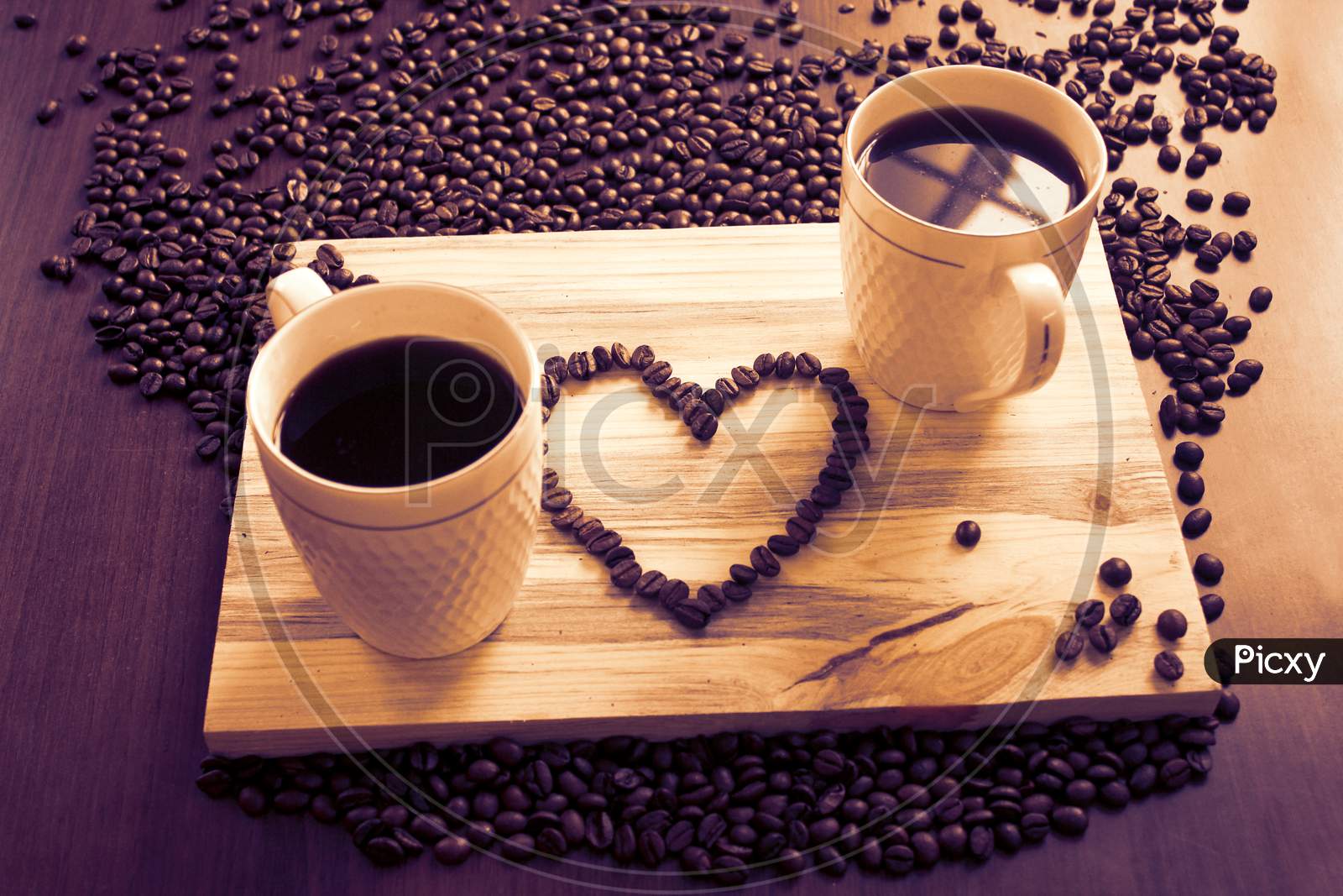 Two Coffee Cup And A Heart Sign With Beans