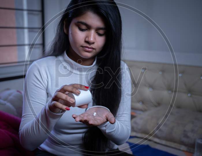 Young Girl Taking Medication Or Medicine Pills Before Going To Sleep - Concept Of Insomnia, Mental Disorder Or Sleeping Problem