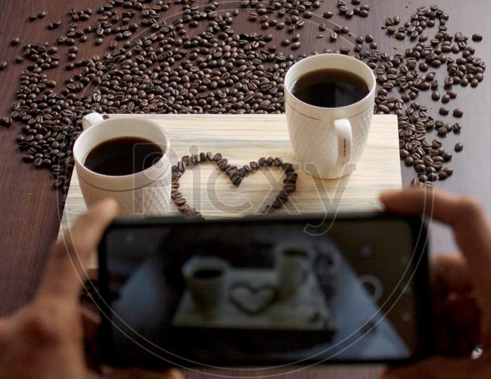 Coffee Beans In A Heart Shape Shot Through Mobile Phone