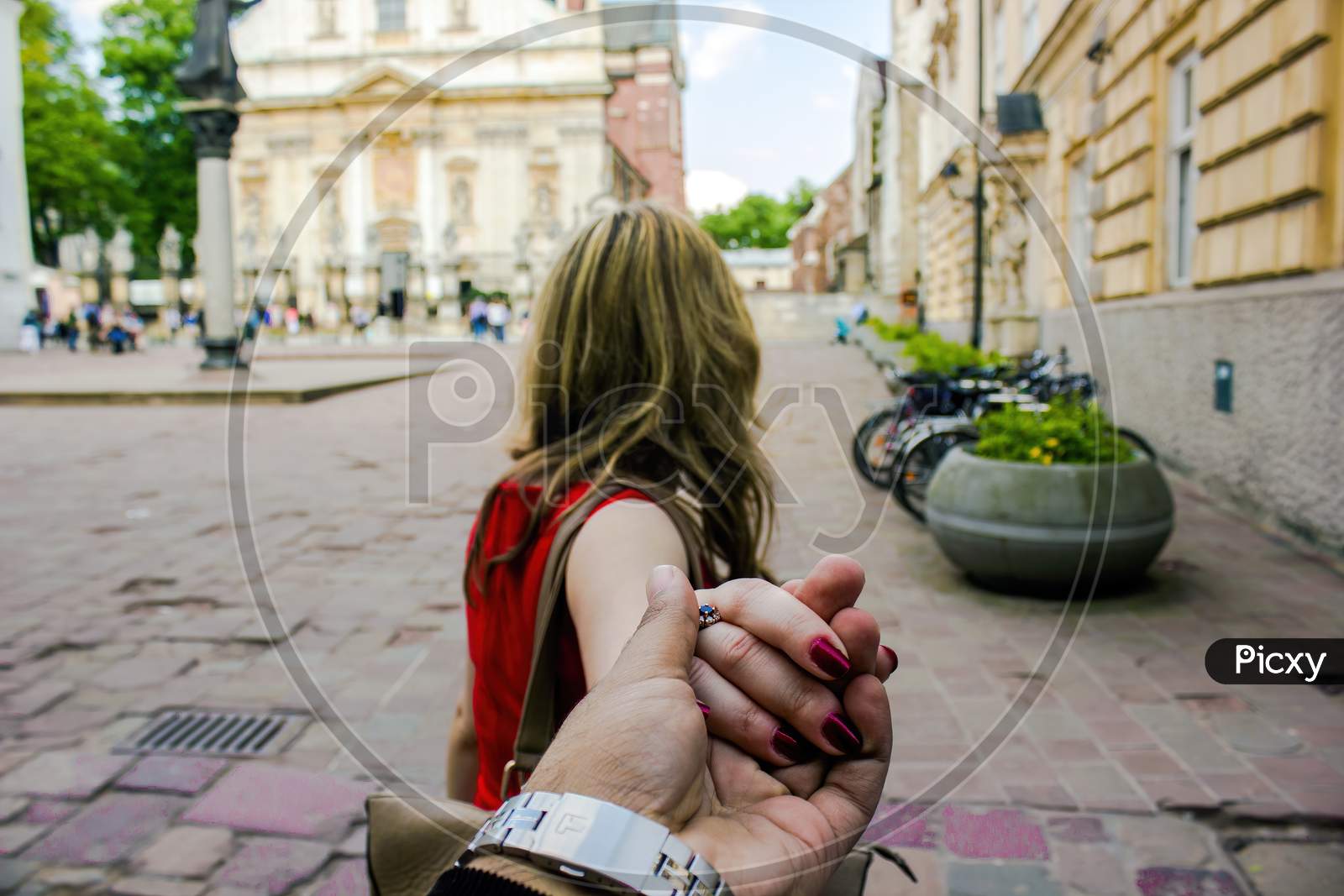Travel In Famous City Follow Me Woman In An European City Holding Hand Of Boyfriend Or Husband Following Leading Girlfriend Walking. Tourism, Love, Honeymoon And Romantic Travel Concept