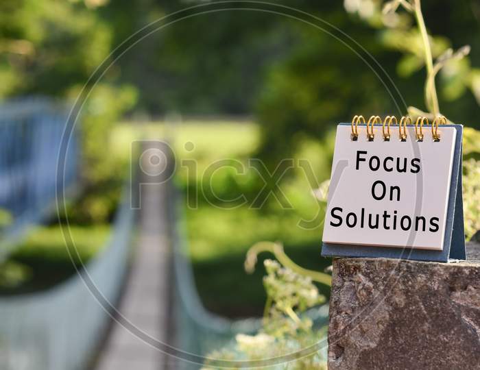 Text Written On White Note With Blurred Background Of Hanging Bridge