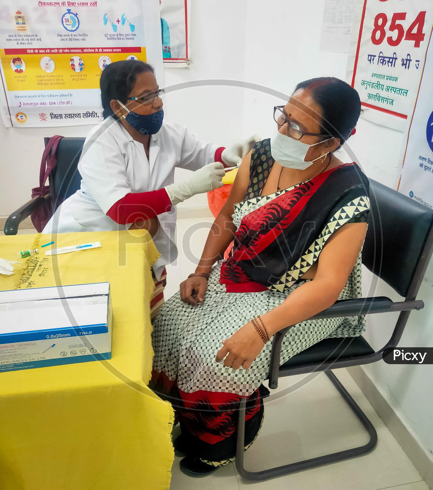 Araria-Bihar-India-03-30-2021- Woman Doctor Or Nurse Giving Syringe Vaccine, Inject Shot To Arm Female Patient. Vaccination, Immunization Or Disease Prevention Against Flu Or Virus Pandemic Concept.