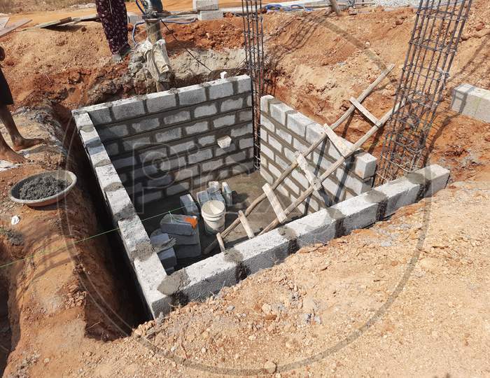 Closeup of construction of building Indian house with pillar, beam, pit and water sump construct using cement block