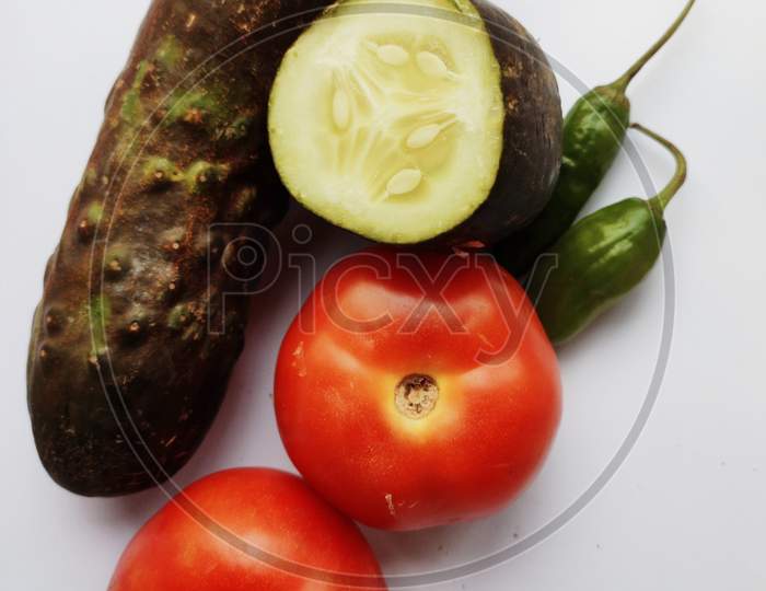 Tomatoes ,Cucumber, Chilies In White Background
