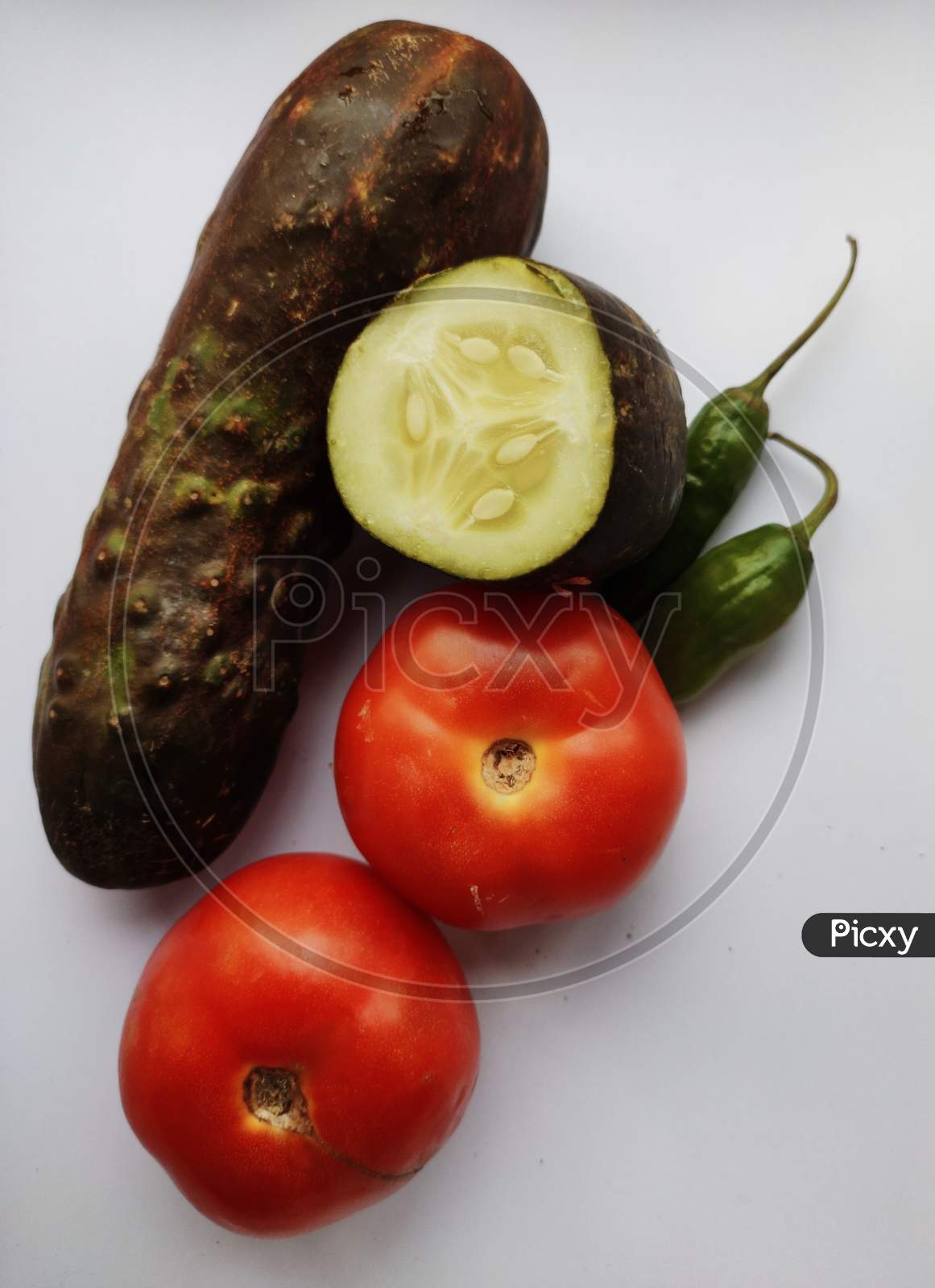 Tomatoes ,Cucumber, Chilies In White Background