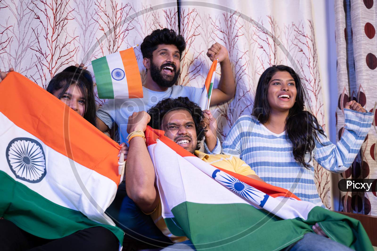 Group Of Friends Shouting India India While Watching Sports Match On Television At Home - Concept Of Group Of People Supporting Indian Cricket People
