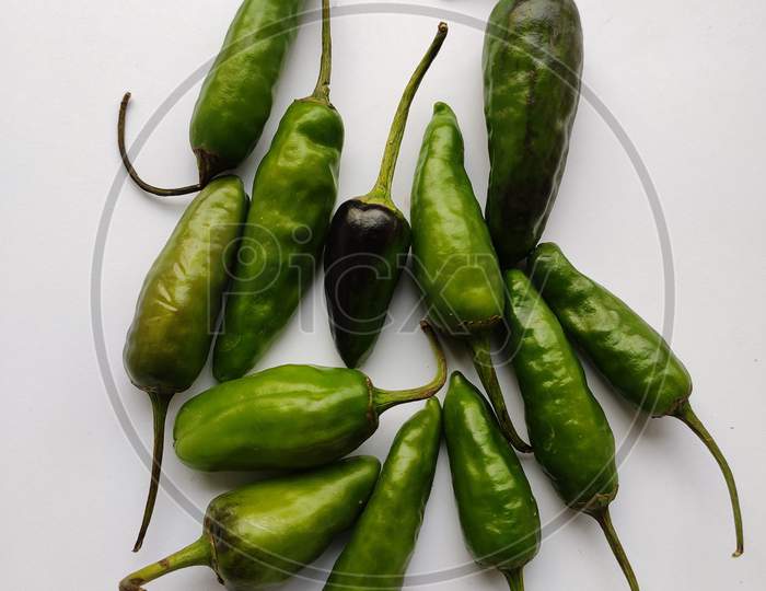 Green Chilies In White Background