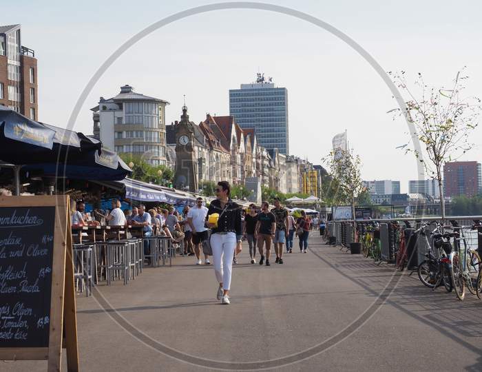 Duesseldorf, Germany - Circa August 2019: People On Rheinuferpromenade On The Bank Of River Rhein In The Altstadt (Old Town)