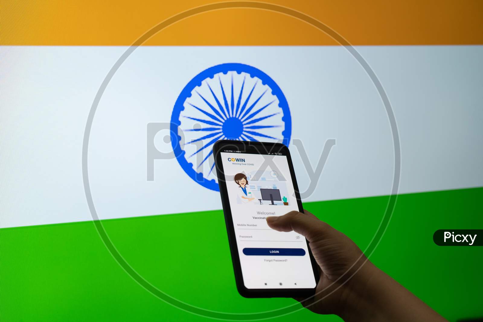 Man Woman Holding The Co-Win Covid19 Coronavirus Vaccination Tracking App Against A Flag Of India As The Innoculation Is Being Done To Ensure Immunity As Cases Surge