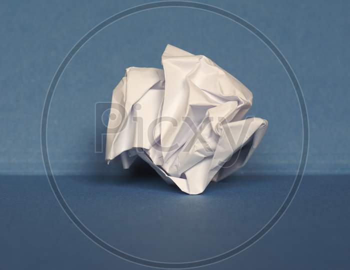 Crumpled Paper Over Blue Background With Copy Space