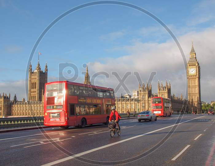 London, England, Uk - October 23: Double Decker Bus Crossing The World Famous Westminster Bridge In Front Of The Houses Of Parliament On October 23, 2013 In London, England, Uk