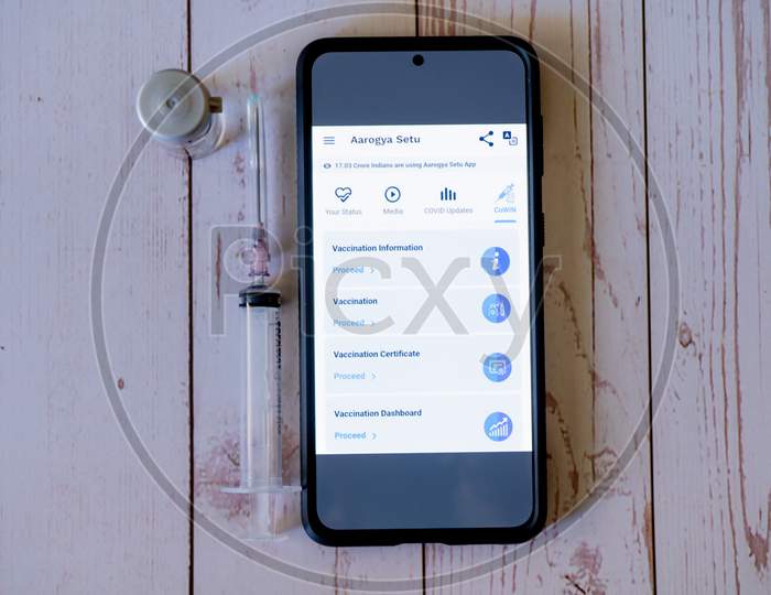 Mobile Phone With Arogya Setu Co-Win App Application Showing Vaccine Tracking Used By Patients And Doctors To Ensure Quick Distribution And Tracking During The Covid19 Coronavirus Pandemic As India Struggles With Lockdowns