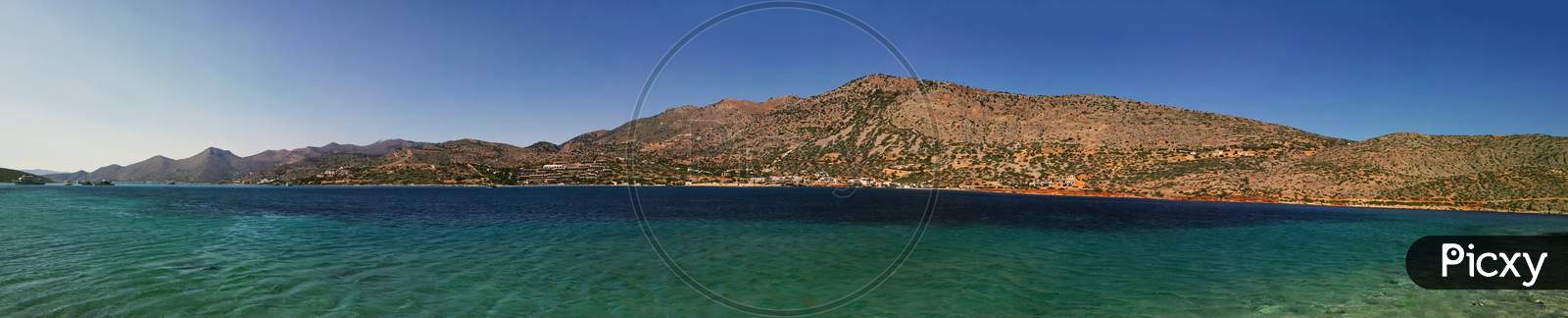 Beautiful Blue Sea Landscape Against Hill Formed As Island Panorama Of Crete, Greece, Europe