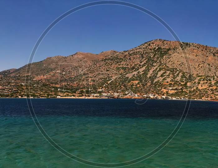 Beautiful Blue Sea Landscape Against Hill Formed As Island Panorama Of Crete, Greece, Europe