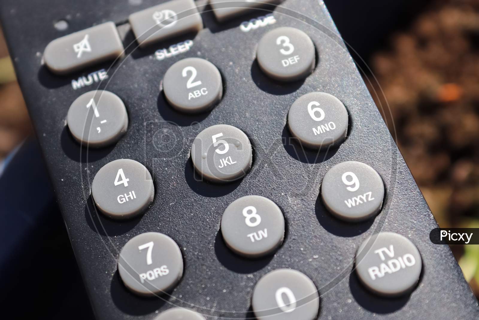 Close Up View On The Number Keys Of A Television Remote Control.
