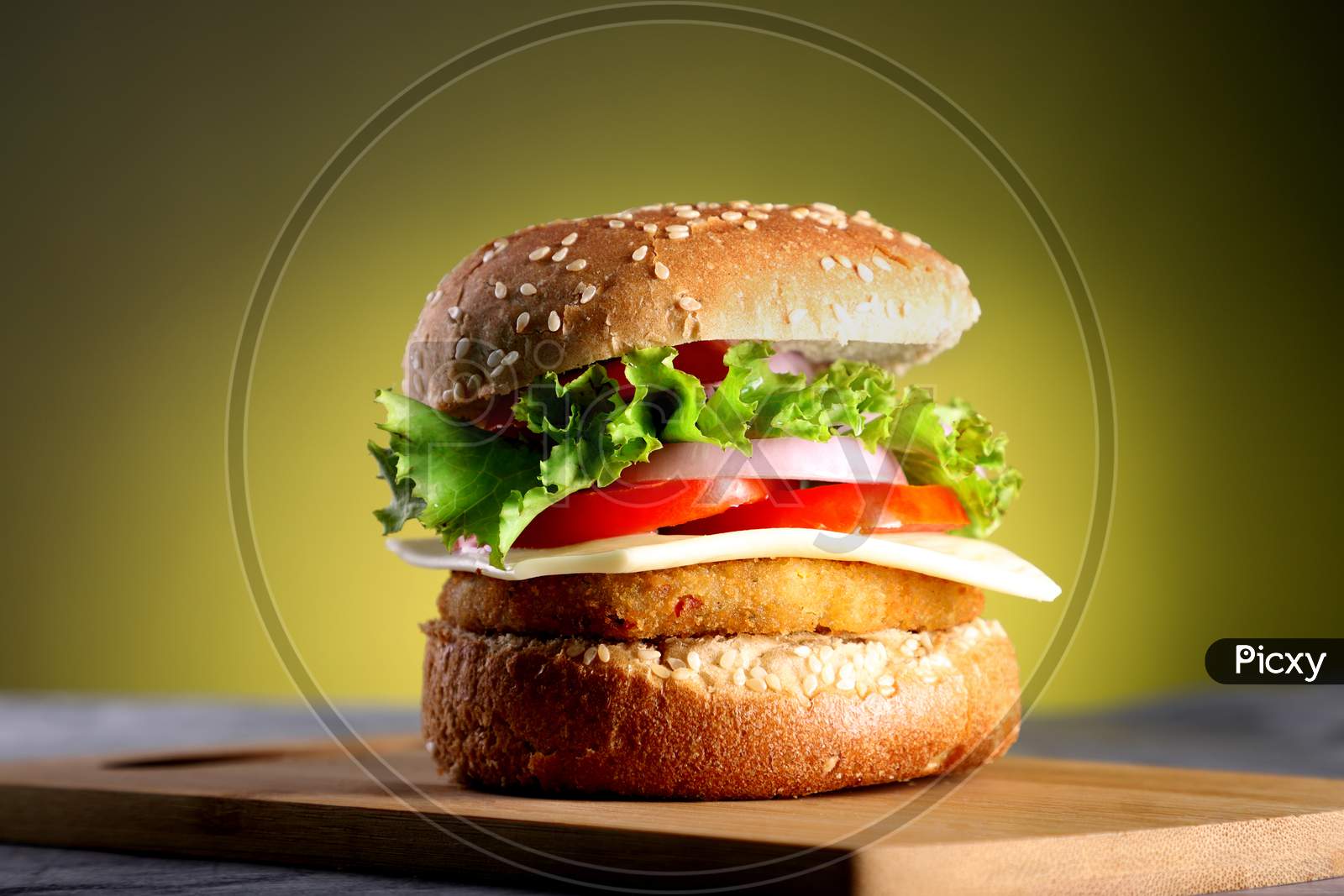 Fast Food - Burger On A Wooden Board And Yellow Background