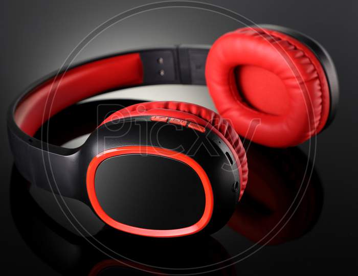 Wireless Bluetooth Headphones Gadget On Black Reflective Background
