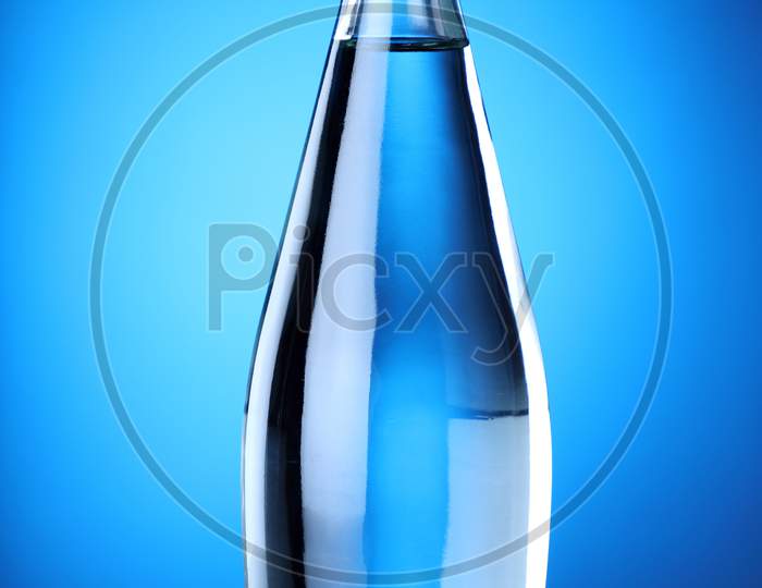 Clean And Pure Mineral Drinking Water Bottle With Blue Background