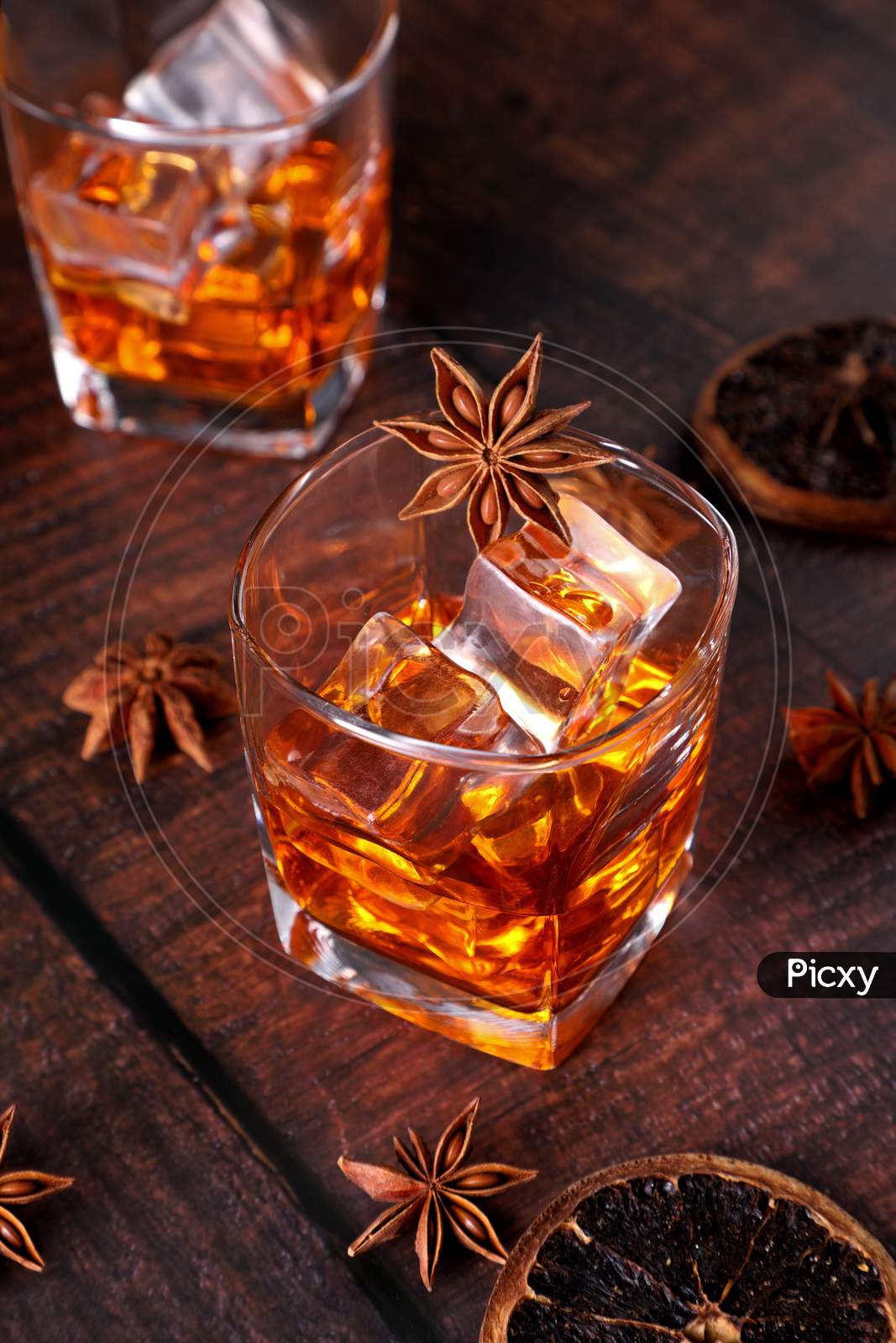 Whisky Rum Or Cold Drink With Star Anise And Dried Orange Slices On Wooden Table