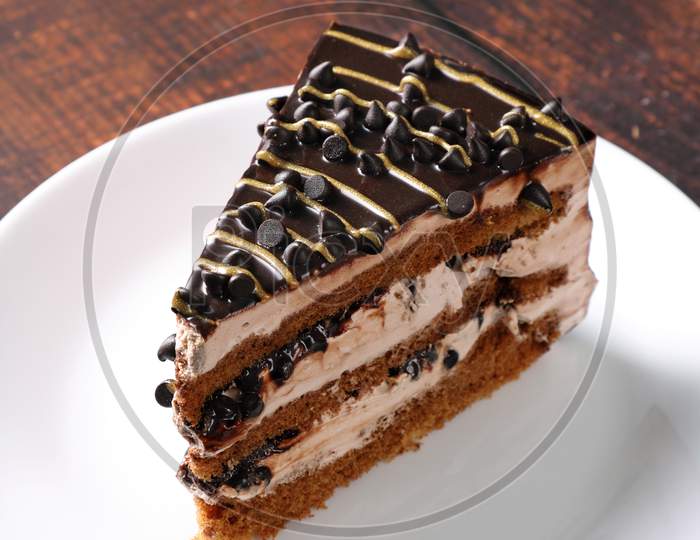 Dessert - A Sweet Cake Slice With Chocolate Chips And Cream