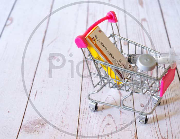 Mini Shopping Cart With A Dose Of Ivermectin Iverbest Tablets With A Syringe And Vial Ampoule Showing Care For Covid19 Coronavirus At Home Available For Purchase Online