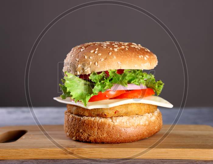 Fast Food - Burger On A Wooden Board