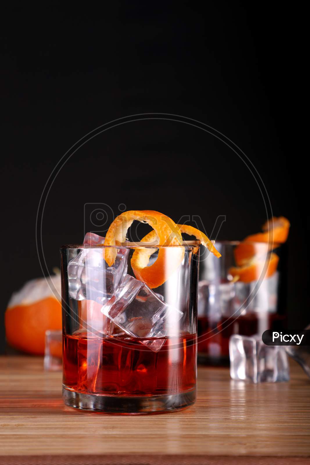 Chilled Alcohol Whisky / Rum Drink With Ice Cube And Orange Peel