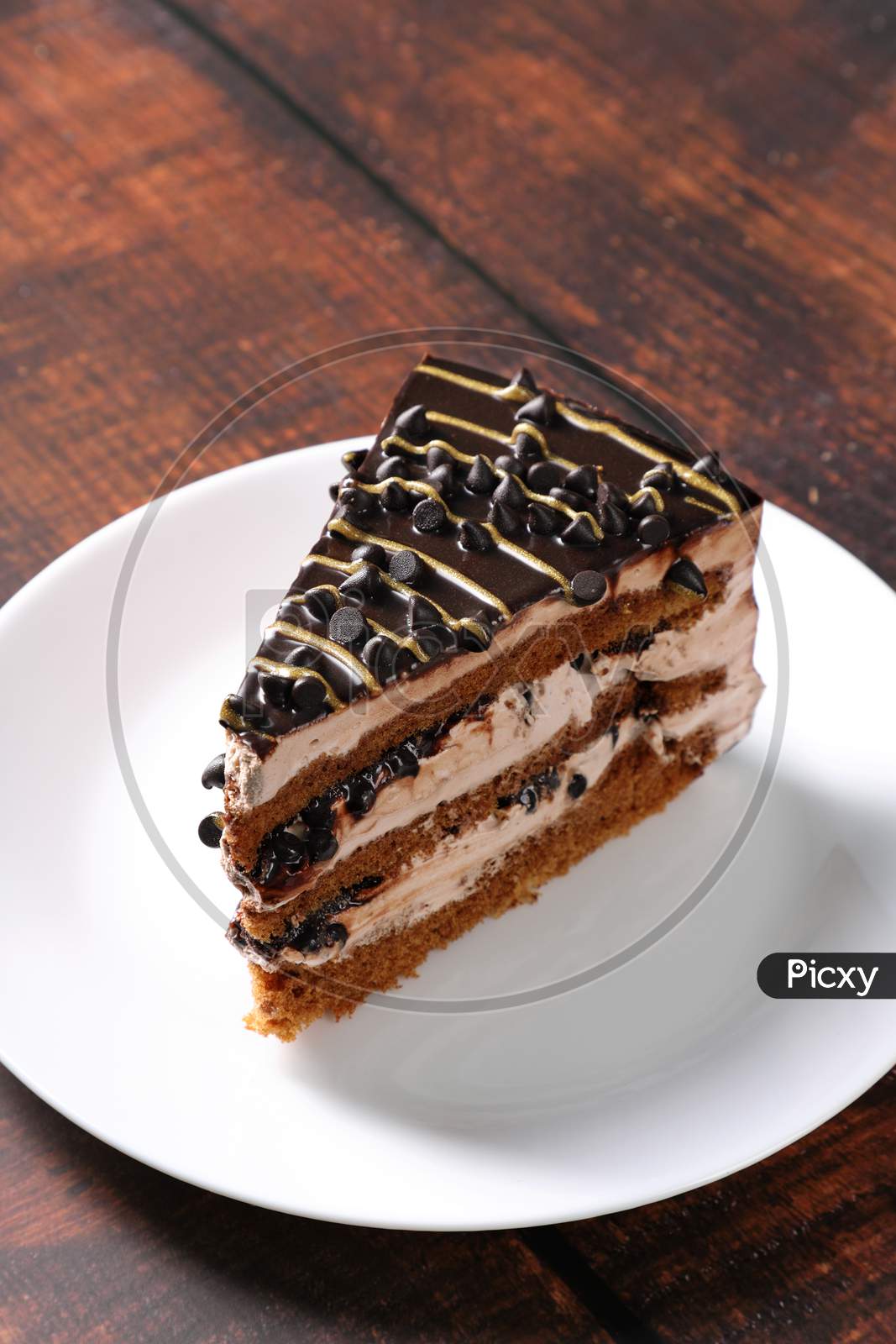 Dessert - A Sweet Cake Slice With Chocolate Chips And Cream