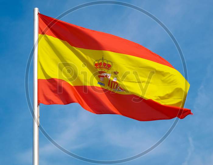 Spanish Flag Of Spain Over Blue Sky