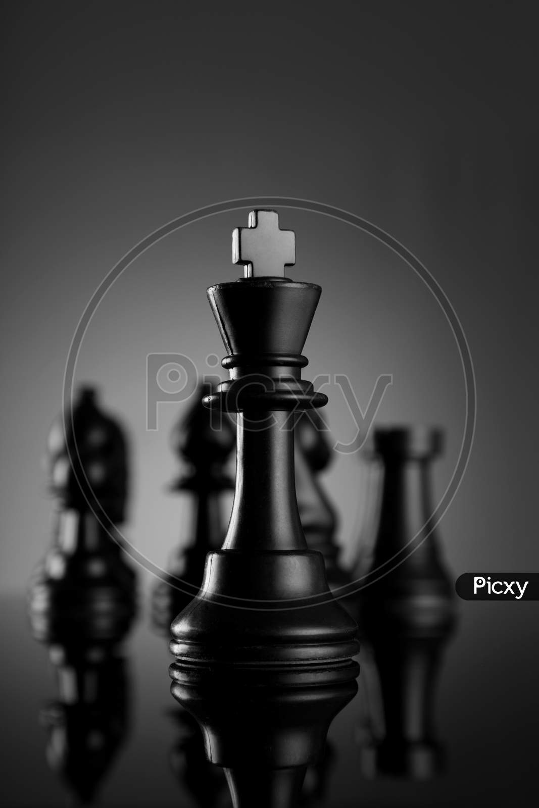 Leadership Chess King With Pieces On Dark Background