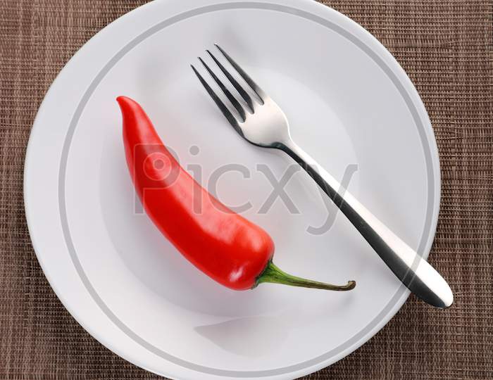 Red Chiili On A Plate With A Fork