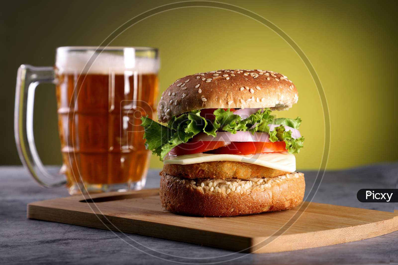 Fast Food Burger With A Beer Mug With Yellow Background