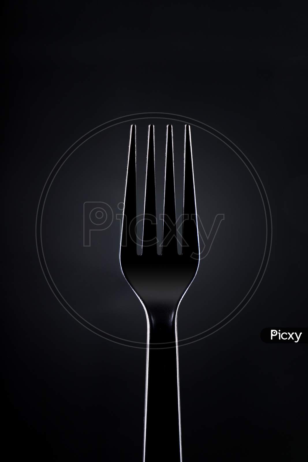 Black Plastic Fork On Dark Background