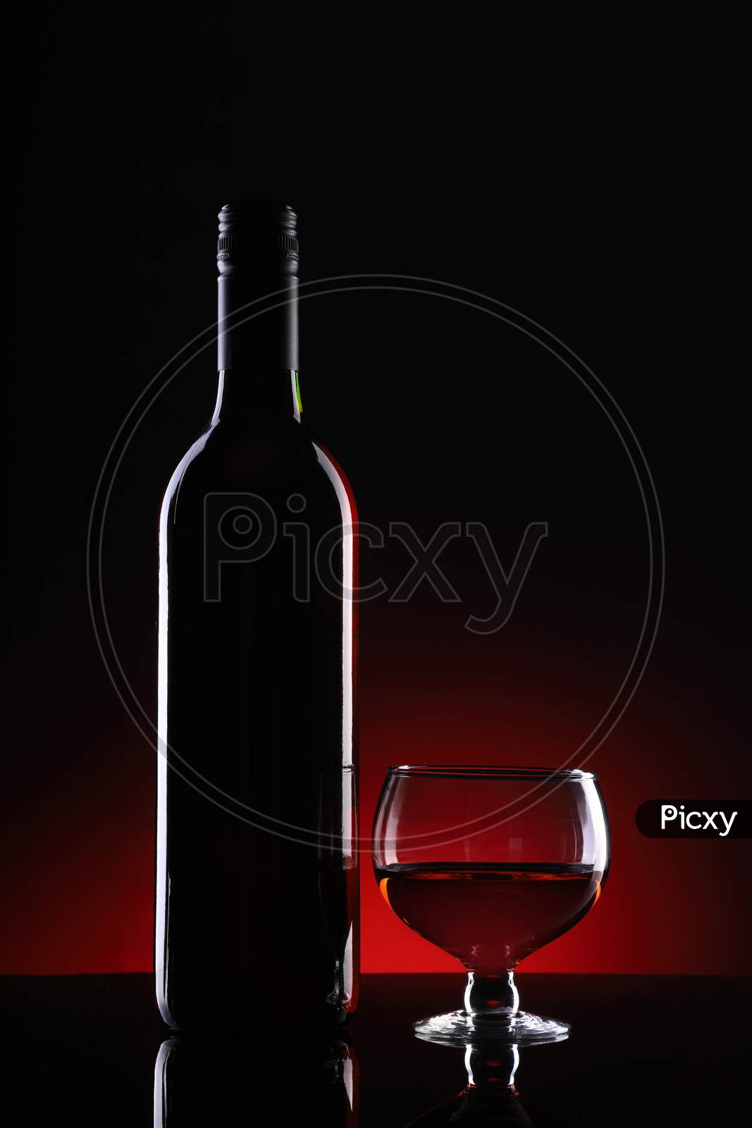 Wine Bottle And Glass On Dark Background