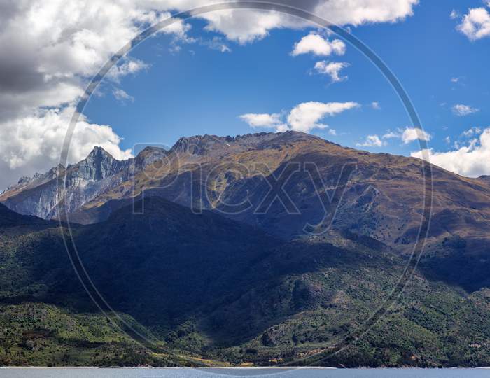 Mountains Above The Shoreline Of Lake Wanaka In New Zealand