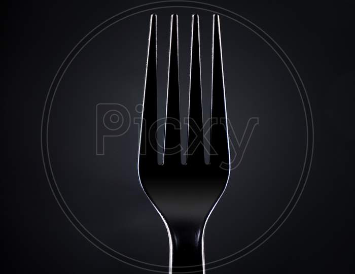 Black Plastic Fork On Dark Background