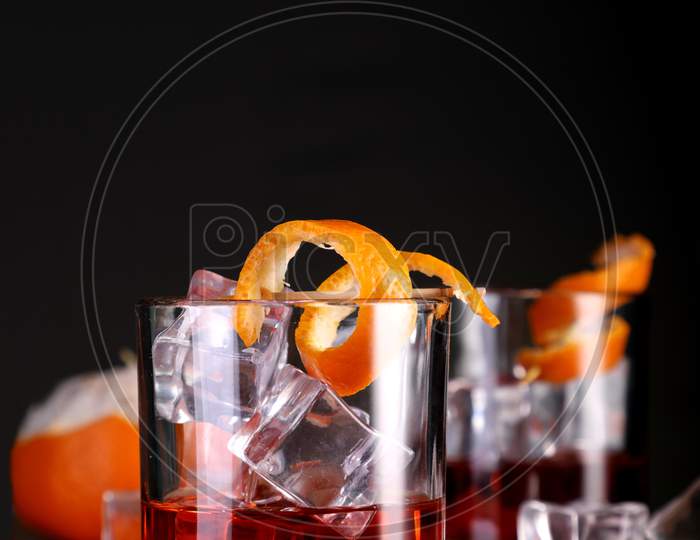 Chilled Alcohol Whisky / Rum Drink With Ice Cube And Orange Peel